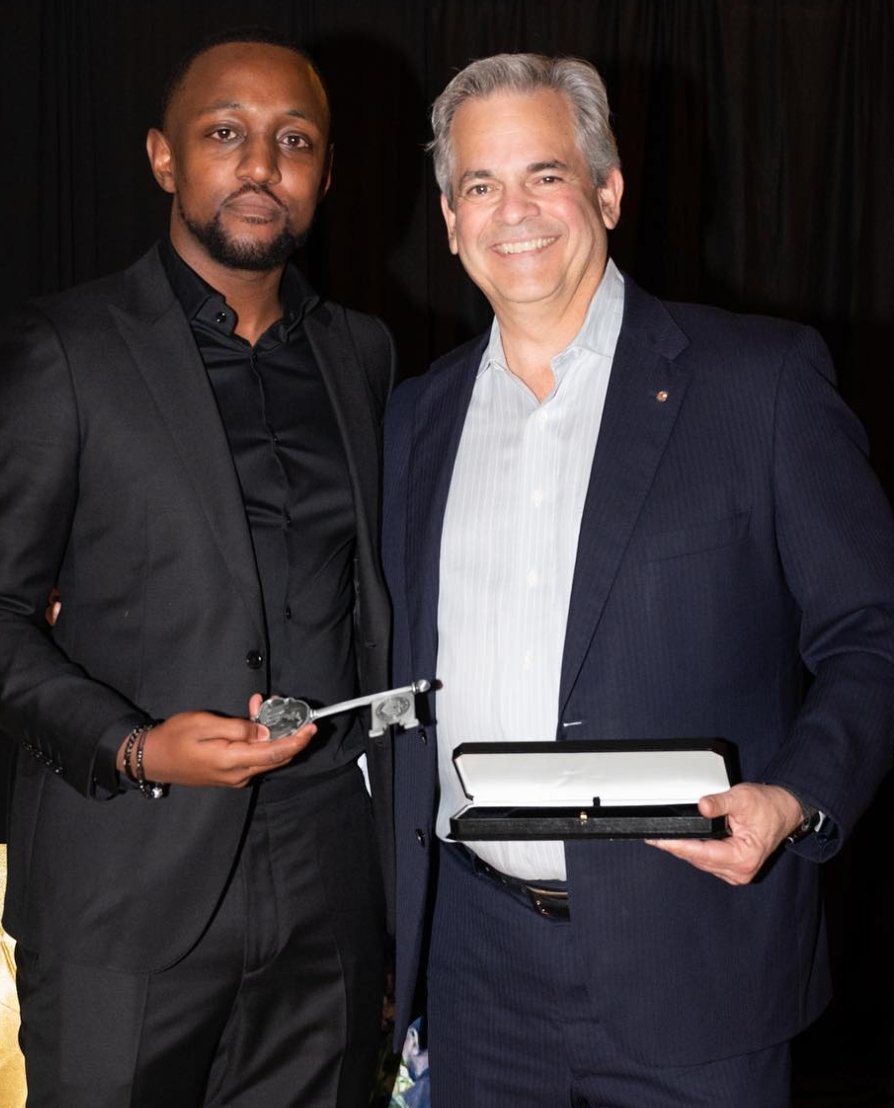 Chas Moore and Austin Mayor Steve Adler stand together holding the Key to the City of Austin, 2022